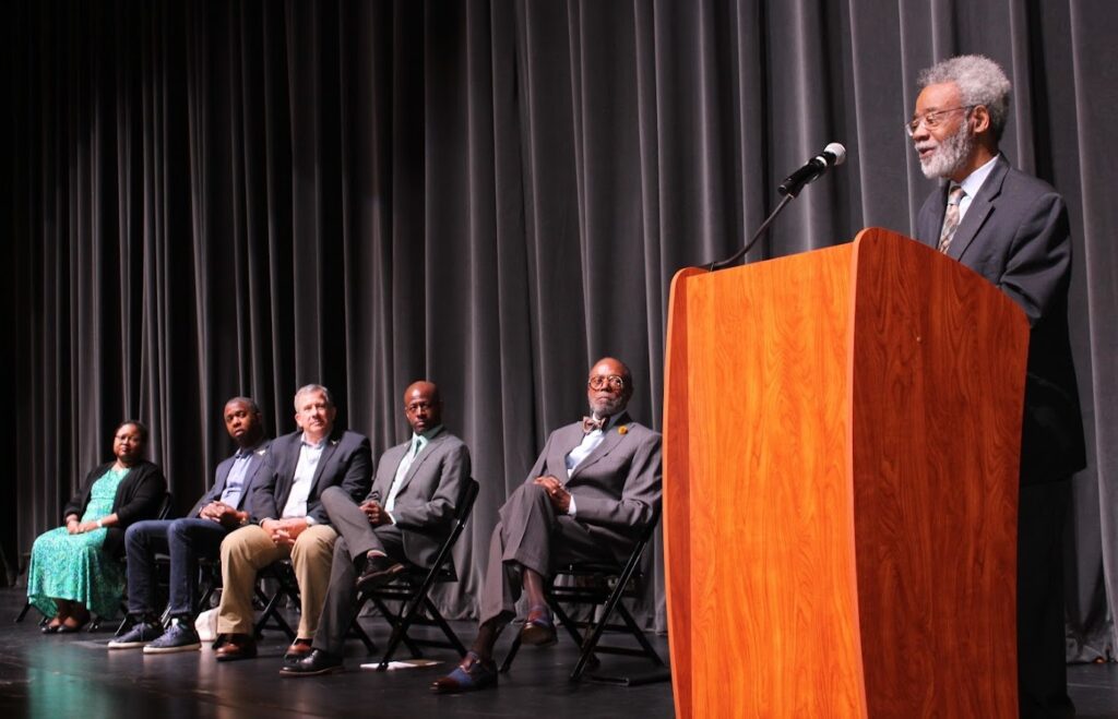 Dr Harry Robinson speaks to the auditorium