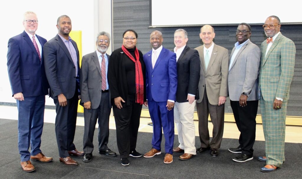 Dr Jason Shelton standing with other panelists